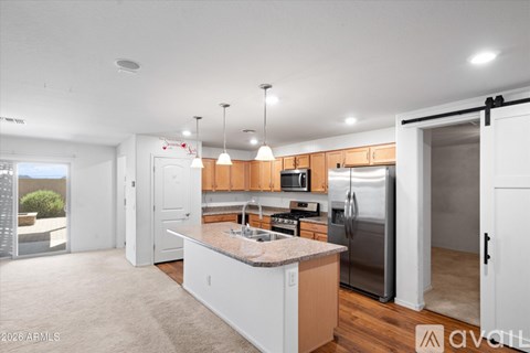 A kitchen with white cabinets and a granite countertop.