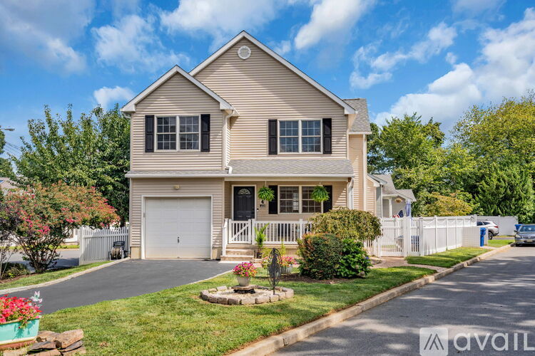 A two-story house with a garage and a front porch.
