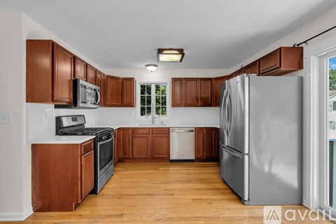 A kitchen with wooden cabinets and a white refrigerator.