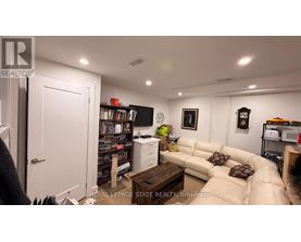 A living room with a couch, a coffee table, and a bookshelf.