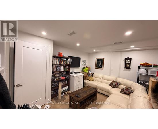A living room with a couch, a coffee table, and a bookshelf.