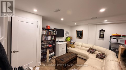 A living room with a couch, a coffee table, and a bookshelf.