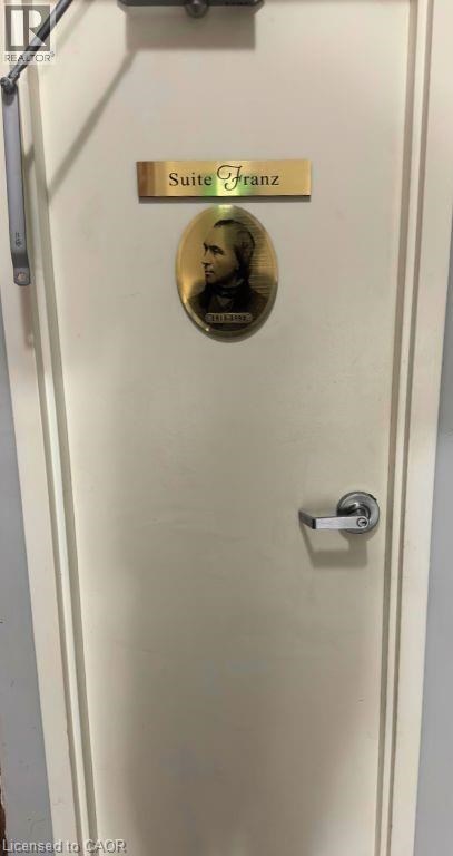 A door with a Suite Franz plaque and a picture of a man's face.
