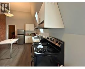 A modern kitchen with a black stove top oven.