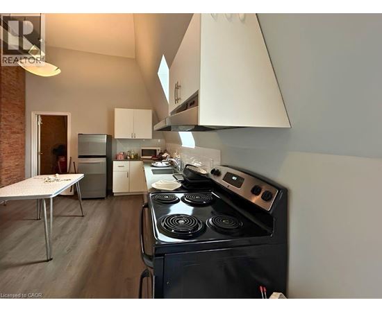 A modern kitchen with a black stove top oven.
