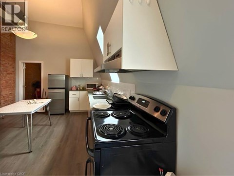 A modern kitchen with a black stove top oven.