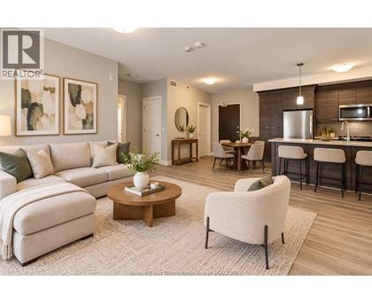 A well-lit living room with a sofa, armchair, and coffee table.