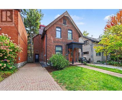 A brick house with a green lawn in front.