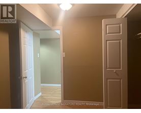 A hallway with a door on the left and a door on the right.