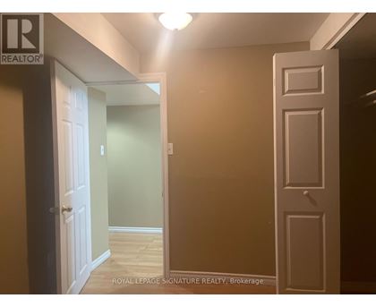 A hallway with a door on the left and a door on the right.