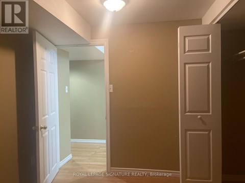 A hallway with a door on the left and a door on the right.