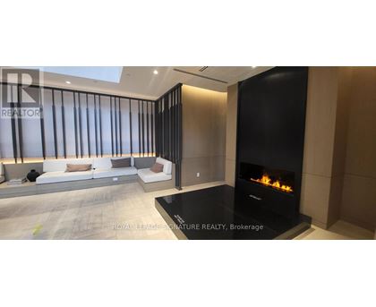 A modern living room with a fireplace and a sofa.