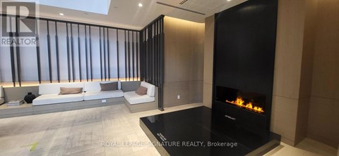A modern living room with a fireplace and a sofa.