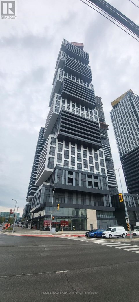 A tall building with a unique design stands out in the cityscape.