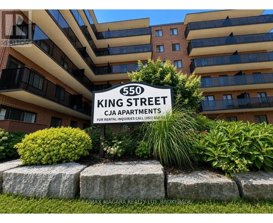 A sign for 550 King Street stands in front of a building.