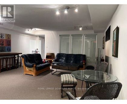 A living room with a glass table and chairs.