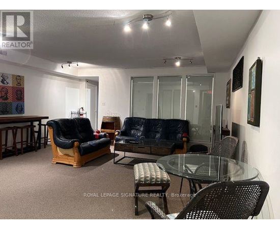 A living room with a glass table and chairs.