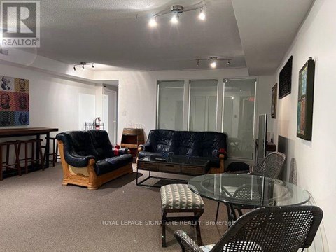 A living room with a glass table and chairs.
