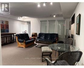 A living room with a glass table and chairs.