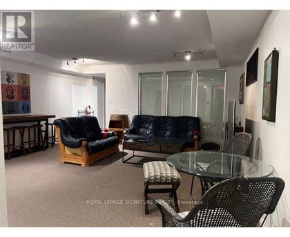 A living room with a glass table and chairs.