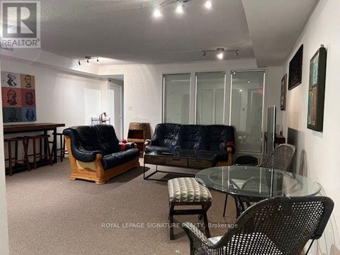 A living room with a glass table and chairs.