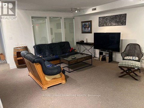 A living room with a black sofa and a TV.