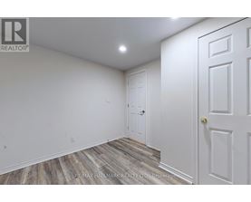A room with a white door and a white wall.