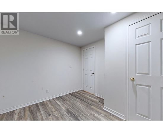 A room with a white door and a white wall.