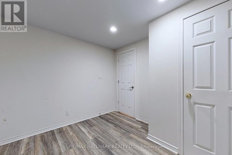 A room with a white door and a white wall.