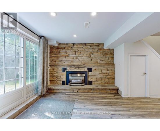 A stone fireplace is built into a wall in a spacious room.