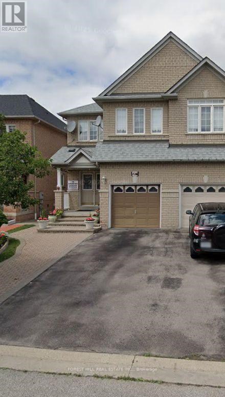 A house with a garage and a car parked in front.