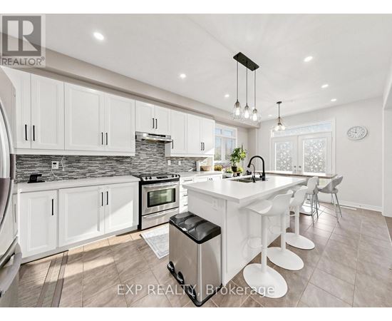 A modern kitchen with white cabinets and a large island.