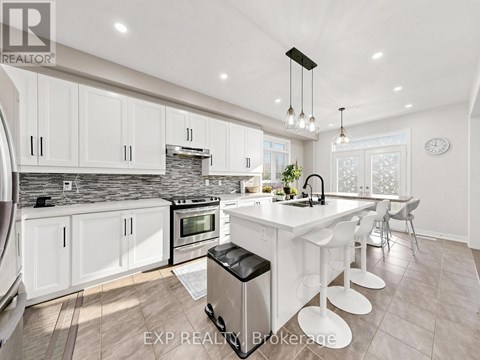 A modern kitchen with white cabinets and a large island.