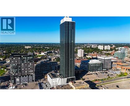 A tall building with a glass facade stands out in a cityscape.