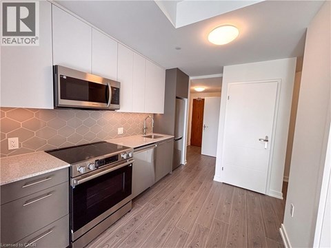 A kitchen with a stove top oven and microwave above it.