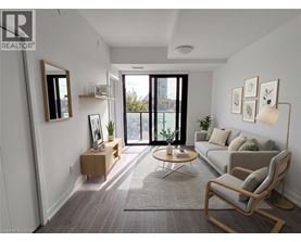 A living room with a grey couch, a wooden chair, and a coffee table.