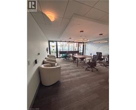 A conference room with a long table and chairs.