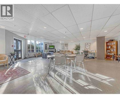 A spacious office with a reception desk and multiple chairs.