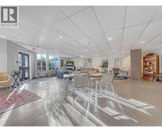 A spacious office with a reception desk and multiple chairs.