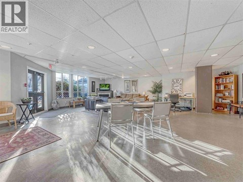 A spacious office with a reception desk and multiple chairs.