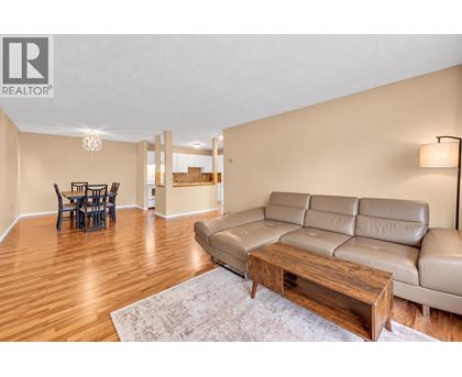 A living room with a leather couch and a wooden coffee table.