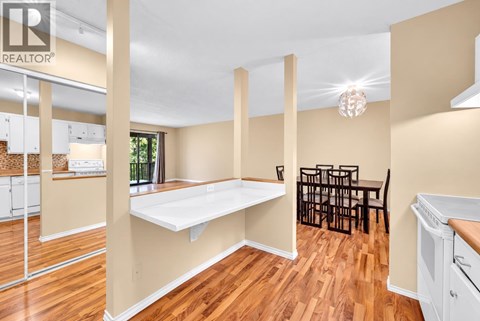 A realtor image of a kitchen and dining area.