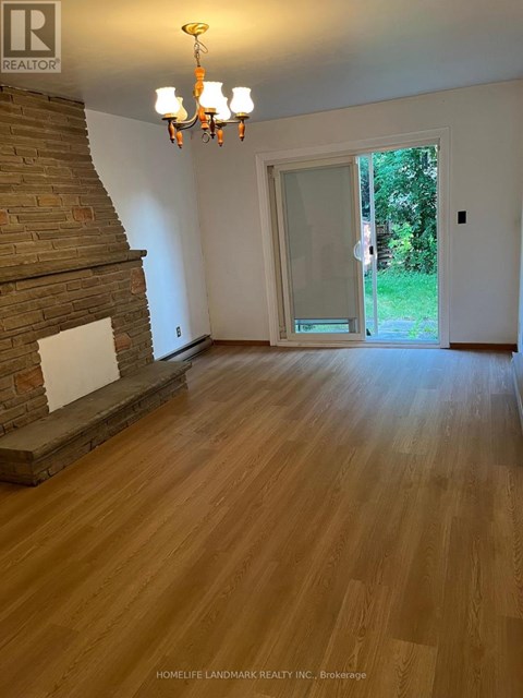 A room with wooden floors and a chandelier.