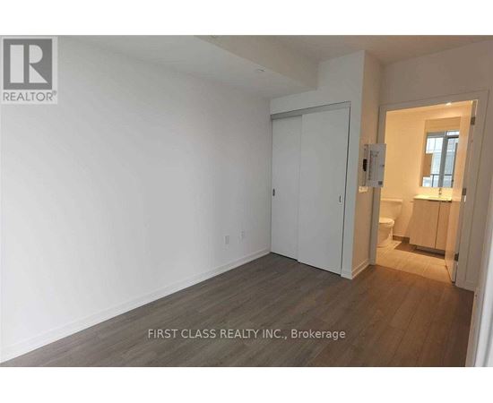 A room with a white door and a window.