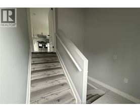 A staircase with wooden steps and white railings.