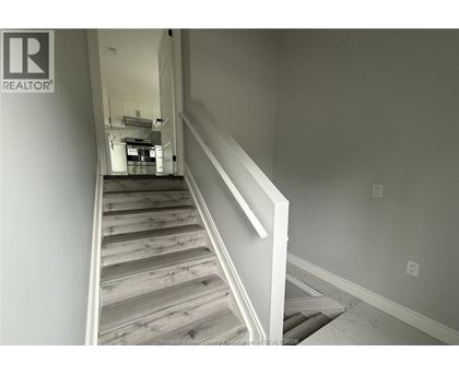 A staircase with wooden steps and white railings.