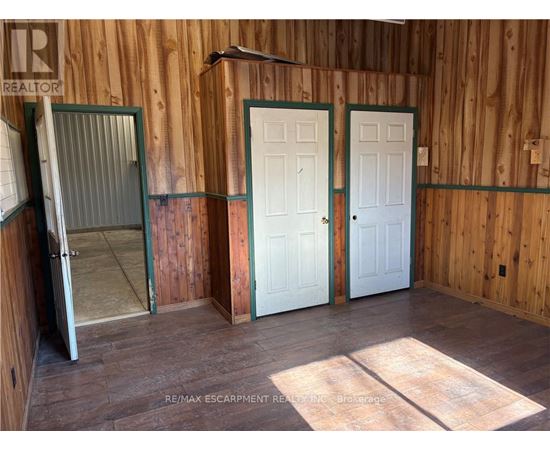 A room with wooden walls and a white door.