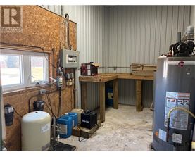 A room with a lot of equipment including a large tank and a machine with a red logo on it.
