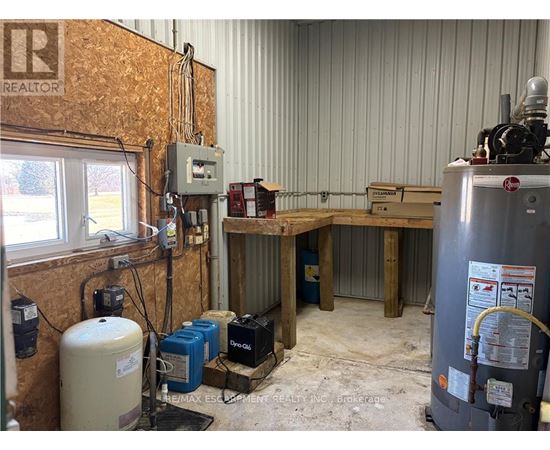 A room with a lot of equipment including a large tank and a machine with a red logo on it.