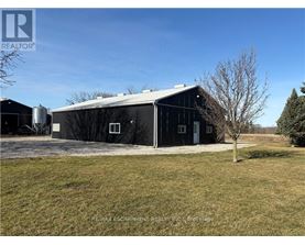 A barn with a tree in front of it.